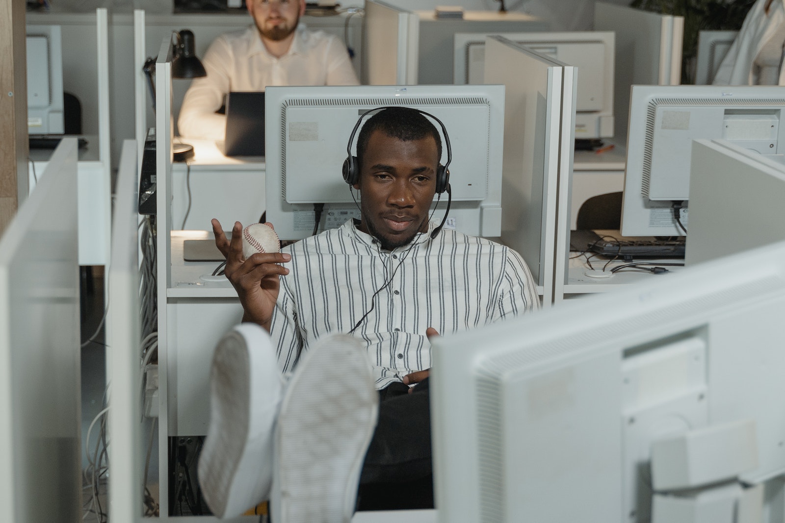Man Wearing Headphones while Working in Call Center Office