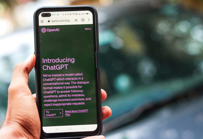 Webpage of ChatGPT, a prototype AI chatbot, is seen on the website of OpenAI, on a smartphone. Examples, capabilities, and limitations are shown.