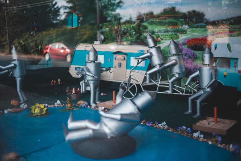 Creative composition in store window of funny steel figurines simulating people activities on street
