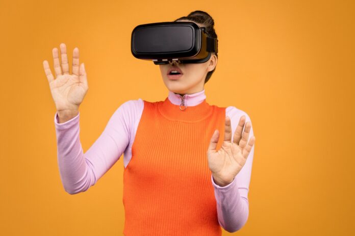 Woman in Long Sleeve Shirt Wearing VR Goggles